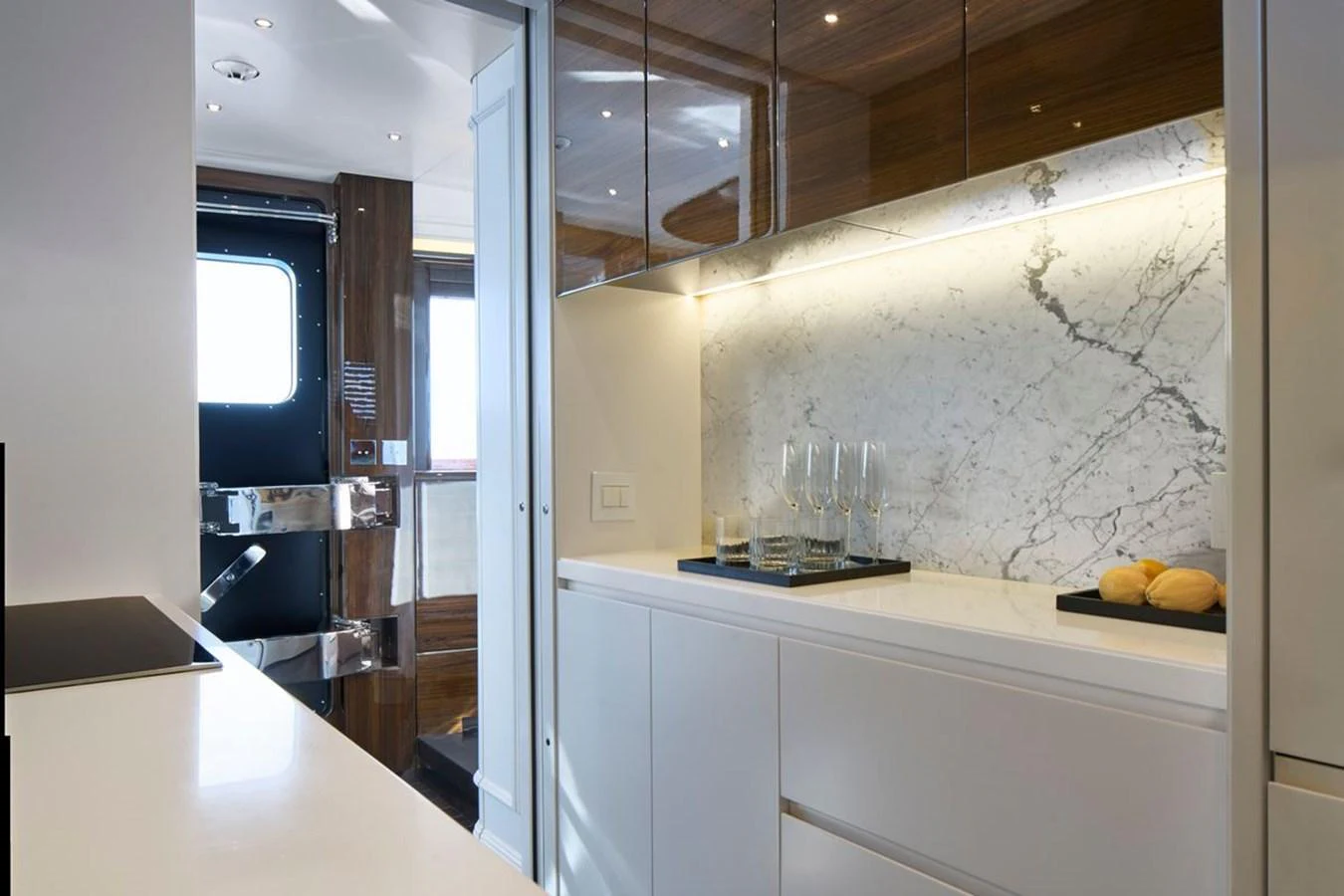 The yacht's galley features sleek cabinetry, a marble backsplash, and modern lighting. aboard PICCHIOTTI 24 Yacht for Sale