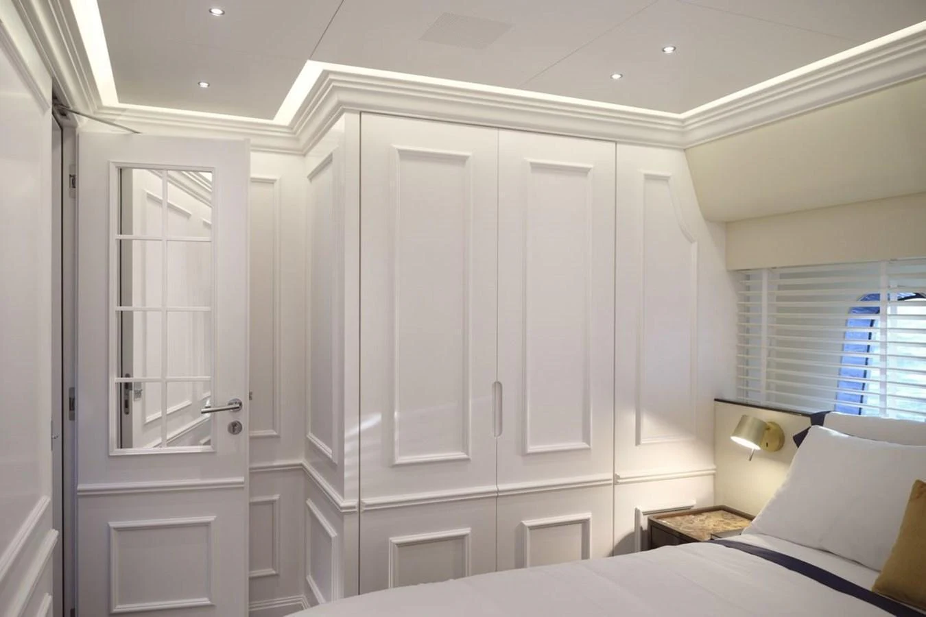 A luxurious stateroom featuring elegant white cabinetry and a comfortable bed. aboard PICCHIOTTI 24 Yacht for Sale