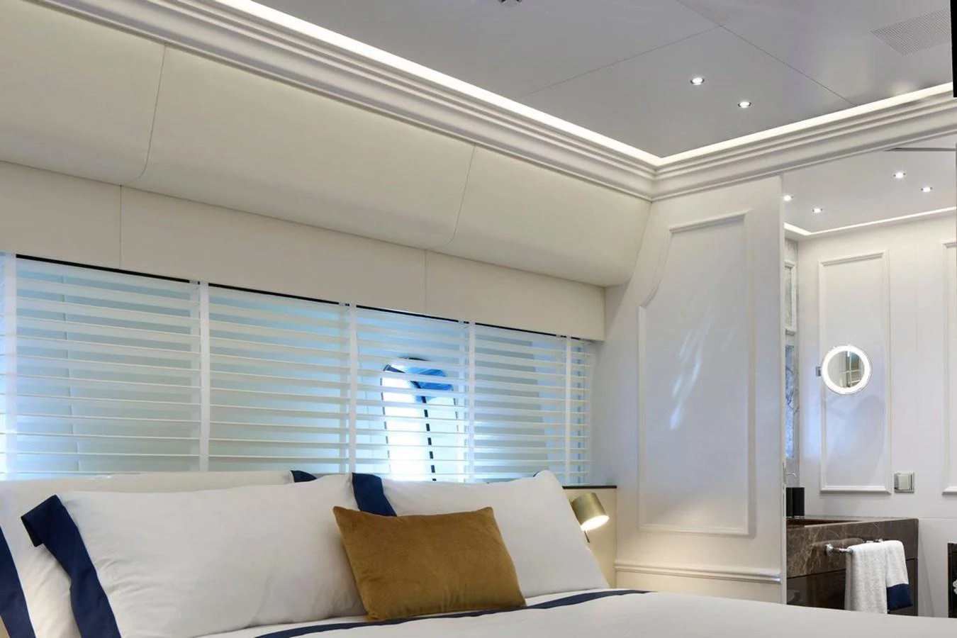 A luxurious stateroom featuring a plush bed with elegant linens and modern lighting. aboard PICCHIOTTI 24 Yacht for Sale