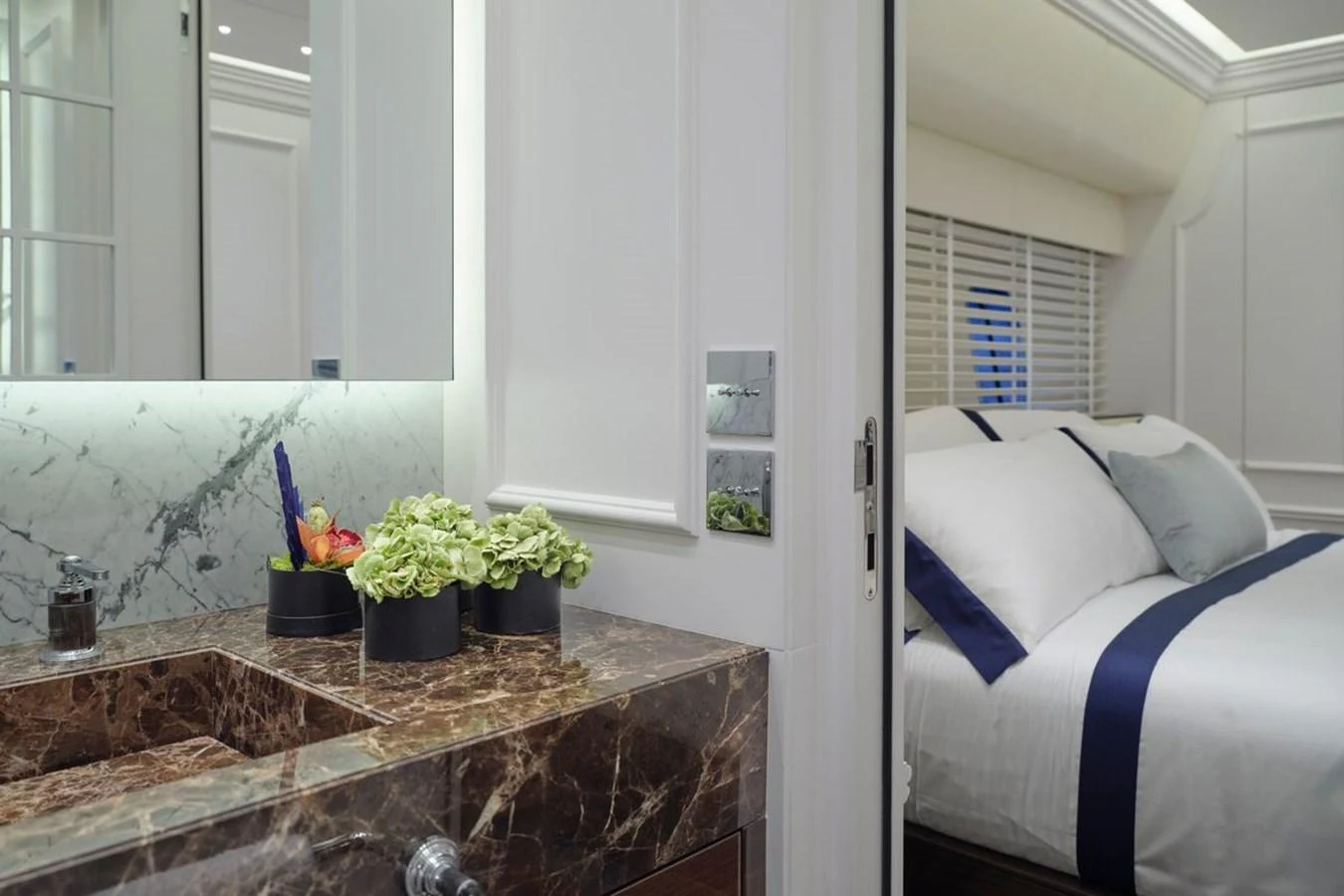 A luxurious stateroom featuring a marble sink and a comfortable bed with elegant linens. aboard PICCHIOTTI 24 Yacht for Sale