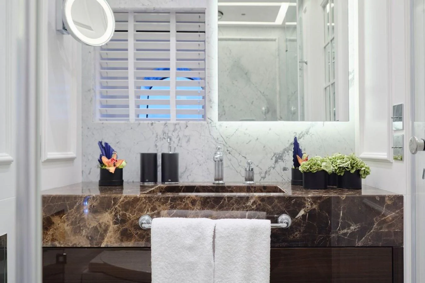 A luxurious bathroom with a marble countertop and modern fixtures. aboard PICCHIOTTI 24 Yacht for Sale