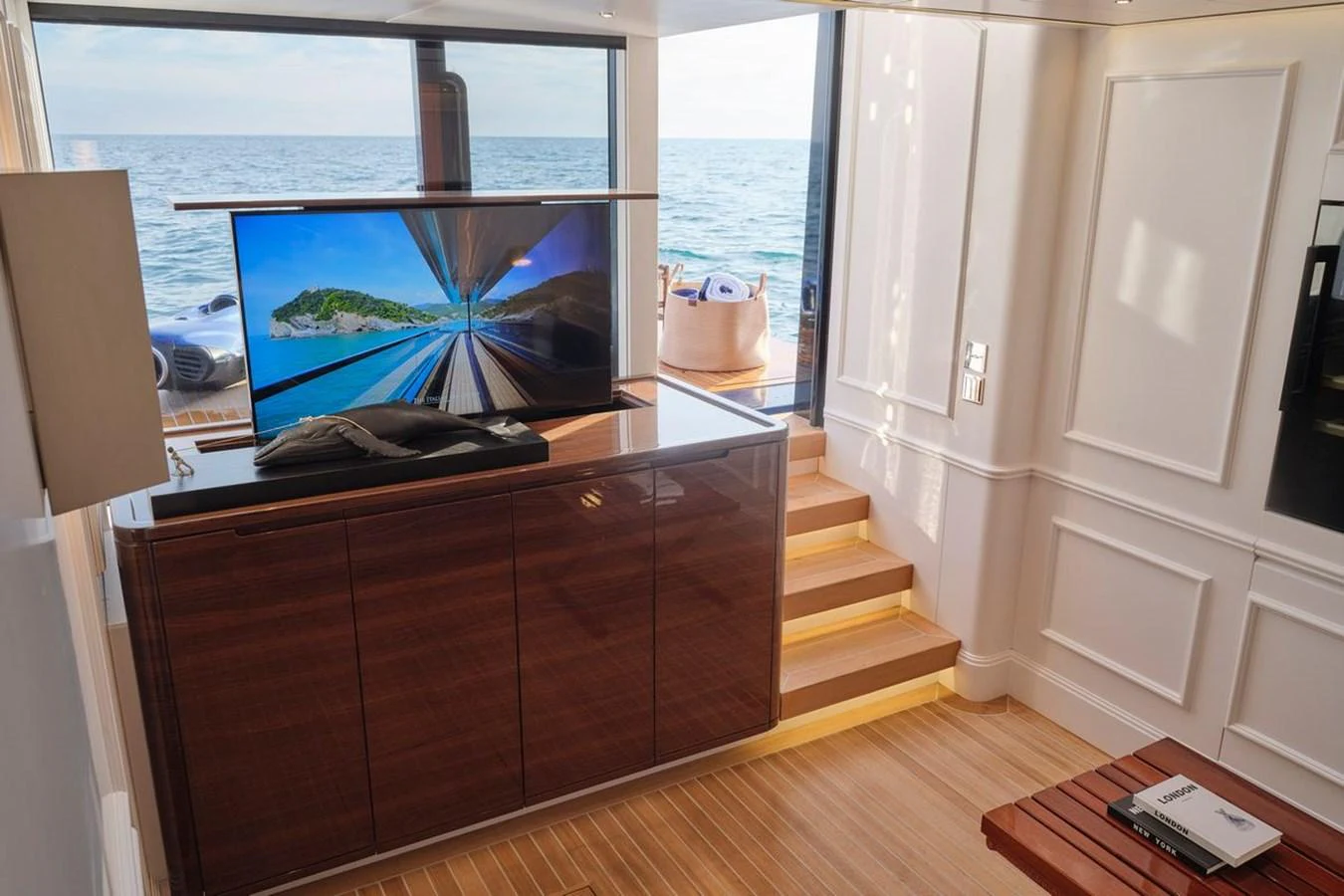 A luxurious interior space featuring a sleek entertainment area with a view of the sea. aboard PICCHIOTTI 24 Yacht for Sale