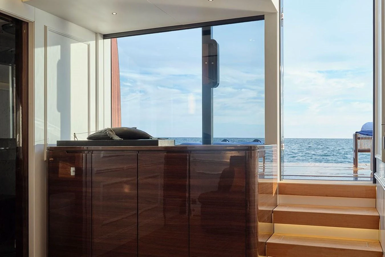 A luxurious interior space with a view of the ocean through large windows. aboard PICCHIOTTI 24 Yacht for Sale