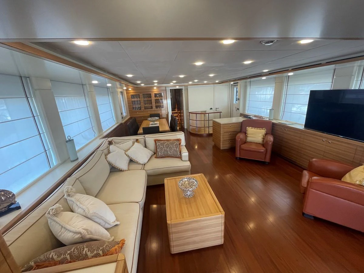 The salon features comfortable seating, a large TV, and elegant decor, creating a cozy and inviting atmosphere. aboard STELLA DEL NORD Yacht for Sale