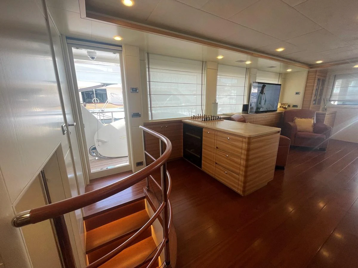 The yacht's salon features a cozy seating area, a television, and a chess set, creating a welcoming and entertaining space. aboard STELLA DEL NORD Yacht for Sale