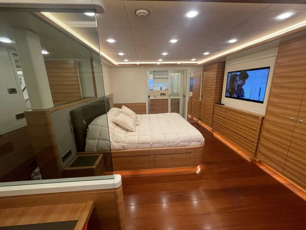 The master stateroom features a spacious bed, ample storage, and modern entertainment amenities. aboard STELLA DEL NORD Yacht for Sale