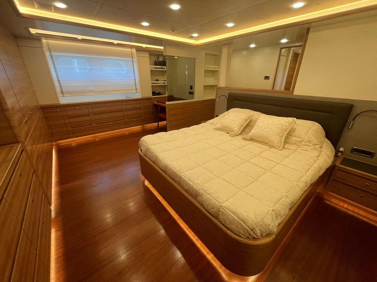 The master stateroom features a spacious bed with elegant lighting and ample storage. aboard STELLA DEL NORD Yacht for Sale