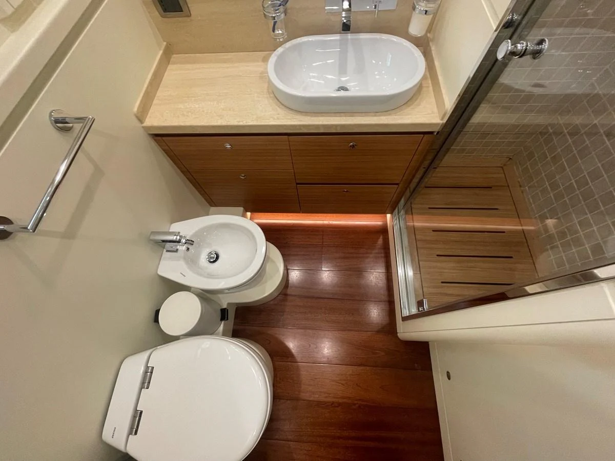 A compact and well-appointed yacht bathroom with modern fixtures and wooden accents. aboard STELLA DEL NORD Yacht for Sale