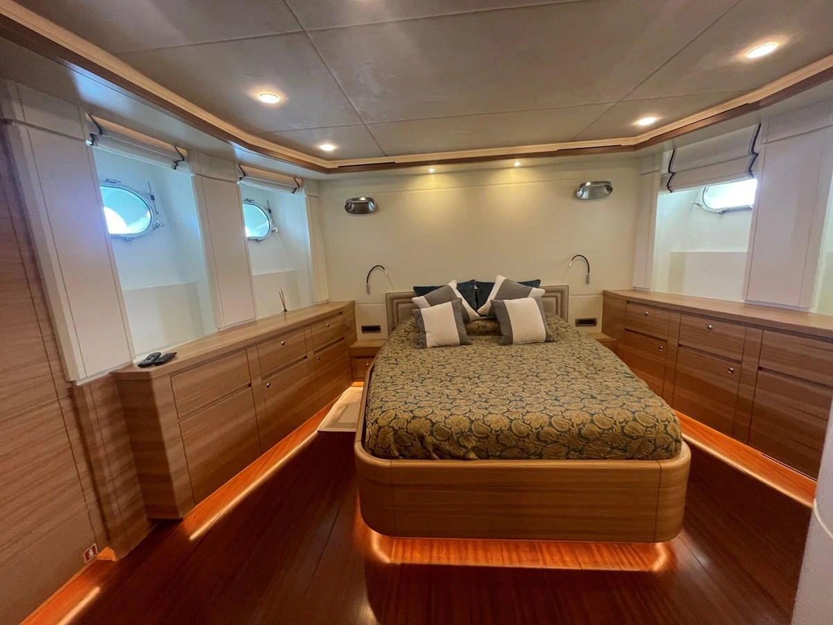 The master stateroom features a luxurious bed with elegant bedding and ambient lighting. aboard STELLA DEL NORD Yacht for Sale