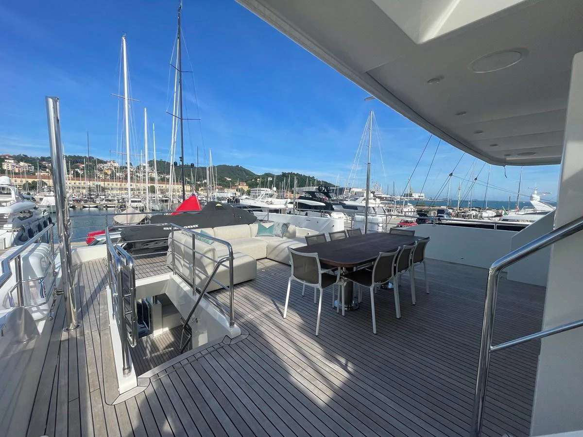 The aft deck features a spacious seating area and a dining table, perfect for alfresco dining and relaxation. aboard STELLA DEL NORD Yacht for Sale