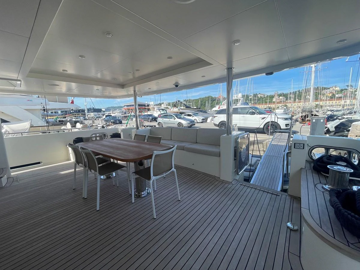 The spacious aft deck features a comfortable dining area with a view of the marina. aboard STELLA DEL NORD Yacht for Sale
