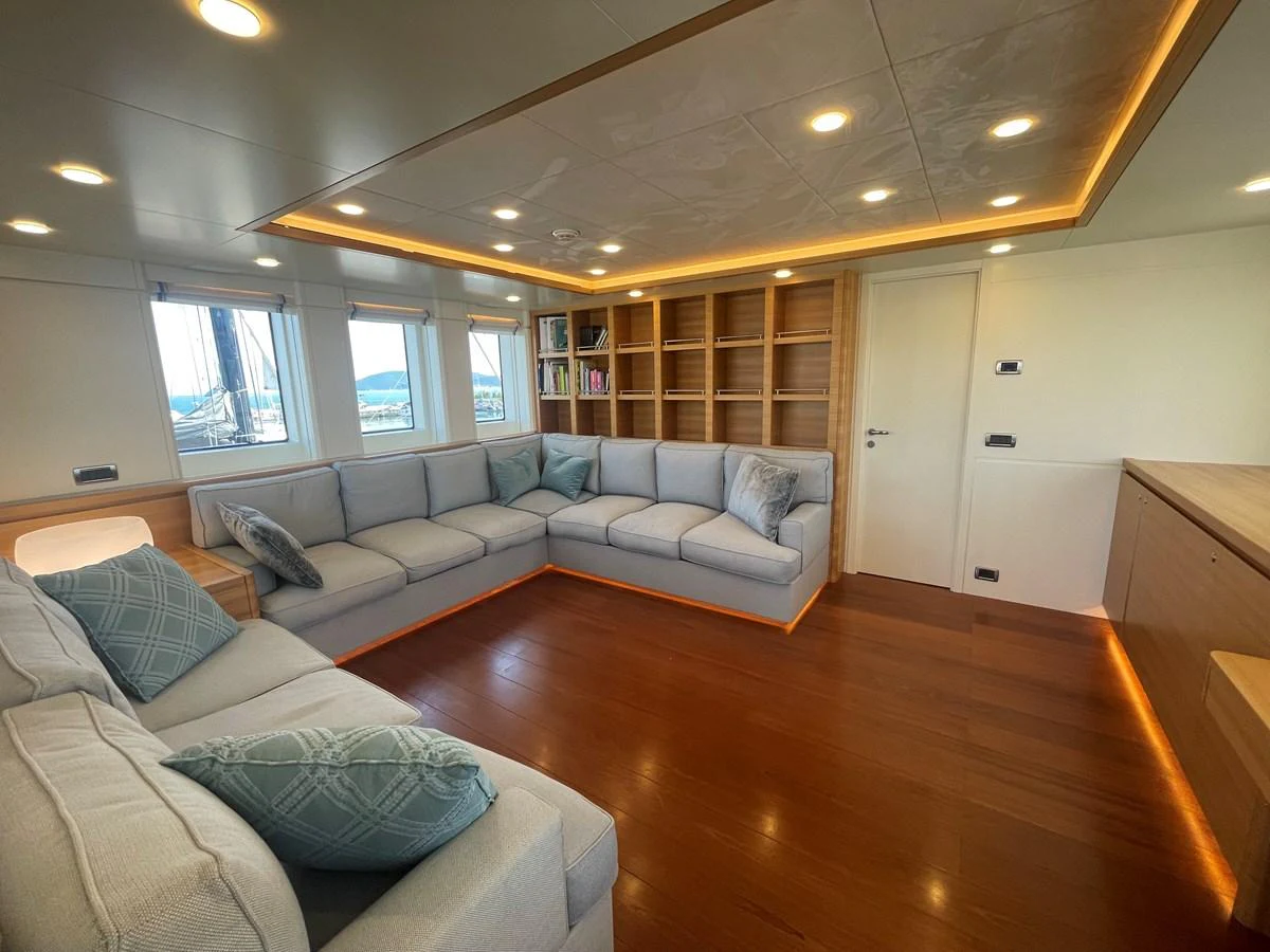The yacht's salon features comfortable seating with ample natural light and elegant wooden flooring. aboard STELLA DEL NORD Yacht for Sale