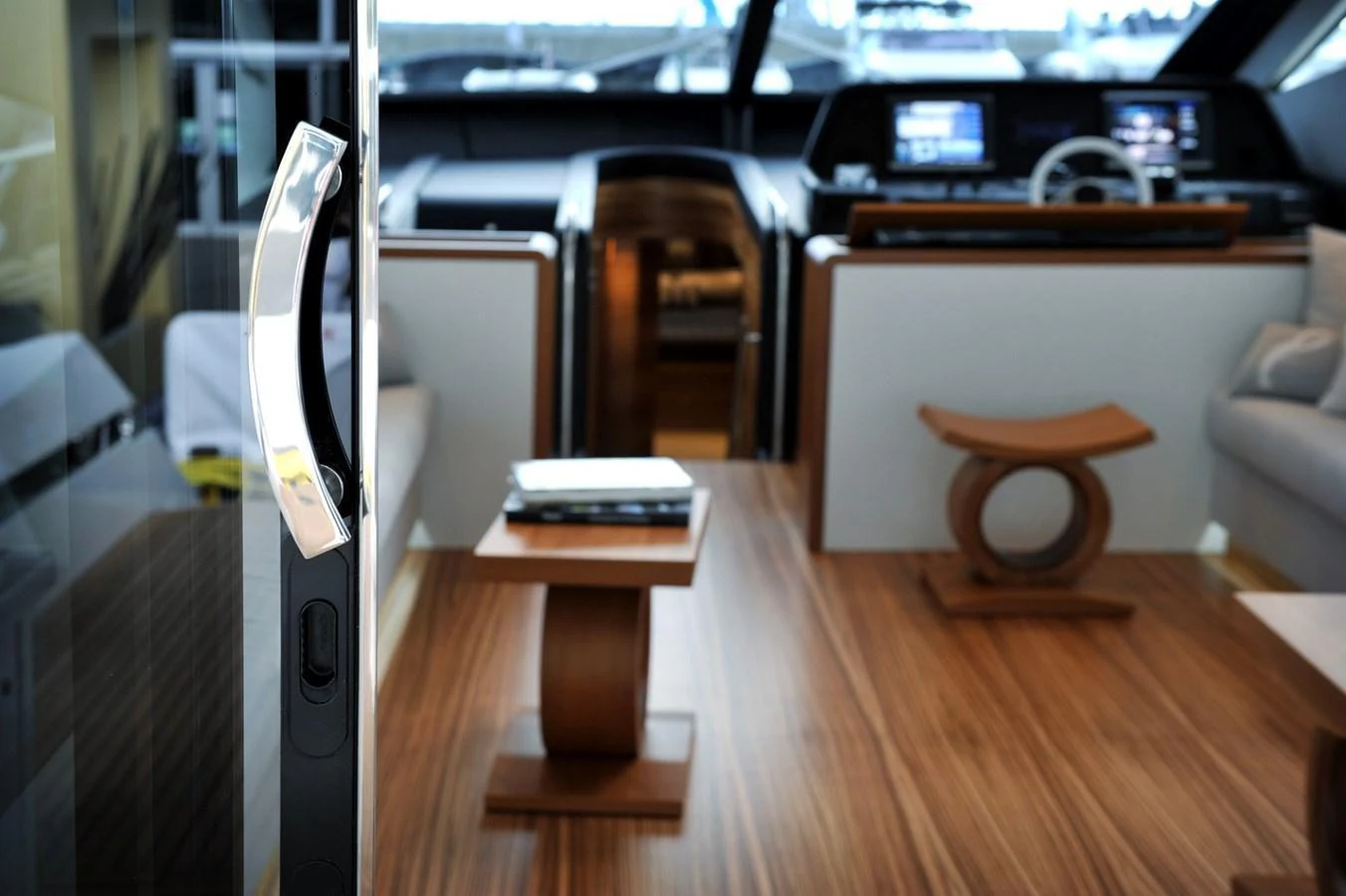 The yacht's interior features a sleek and modern design with wooden flooring and contemporary furniture. aboard SARNICO GRANDE HULL #3 Yacht for Sale