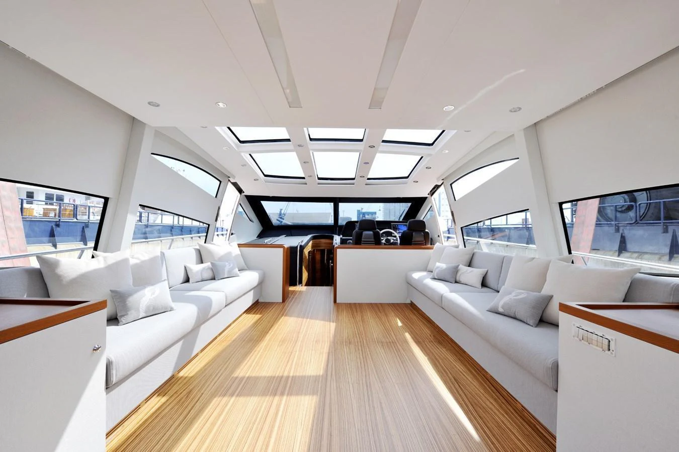 The spacious salon features ample seating and large windows, creating a bright and inviting atmosphere. aboard SARNICO GRANDE HULL #3 Yacht for Sale