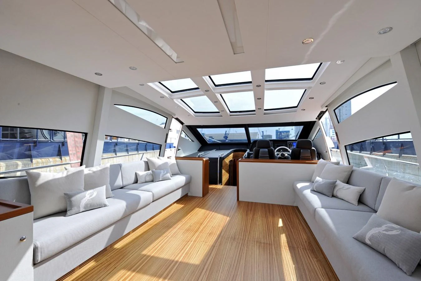 The salon features ample seating with large windows and skylights, creating a bright and inviting space. aboard SARNICO GRANDE HULL #3 Yacht for Sale