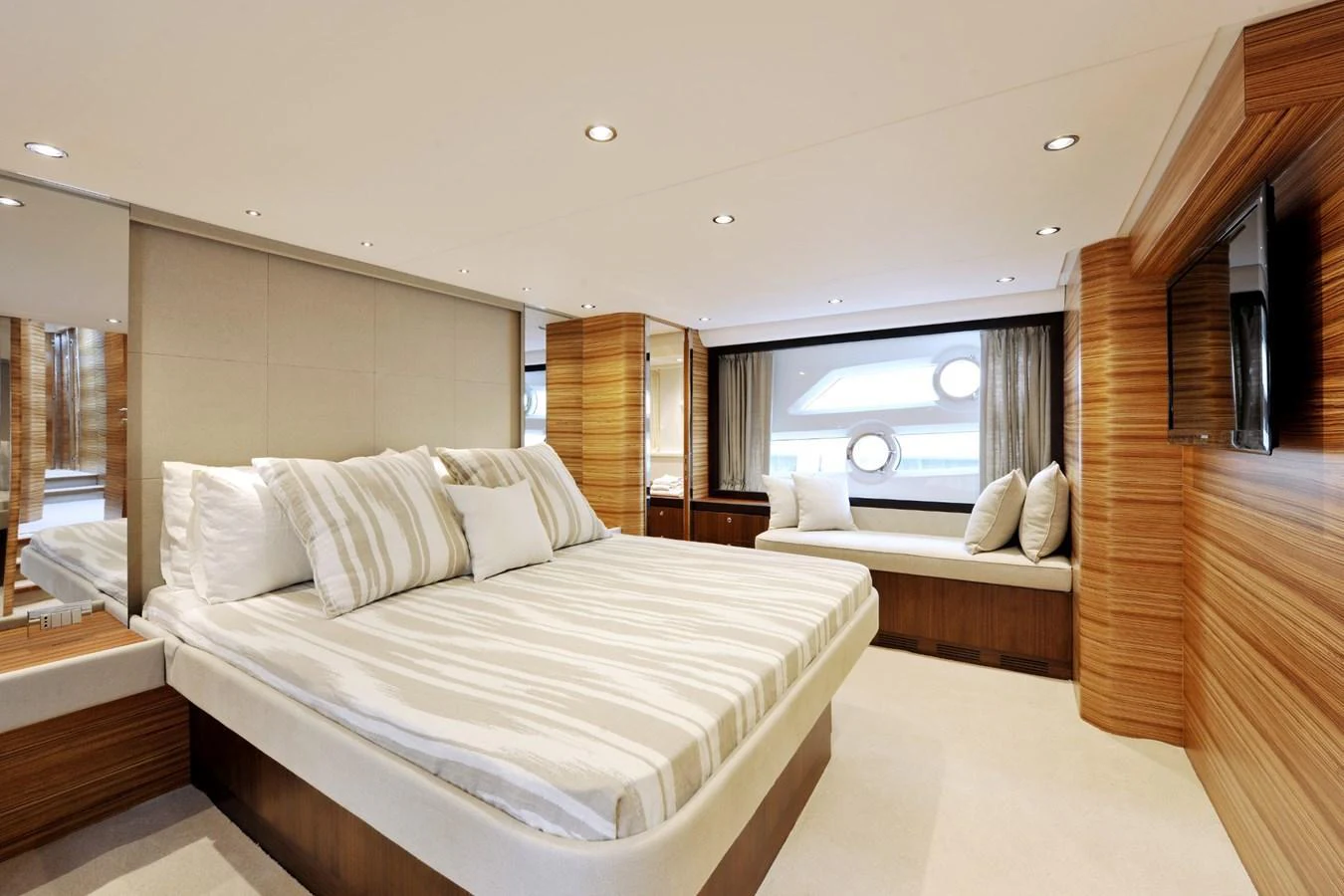 The master stateroom features a luxurious bed with elegant bedding and ample natural light. aboard SARNICO GRANDE HULL #3 Yacht for Sale