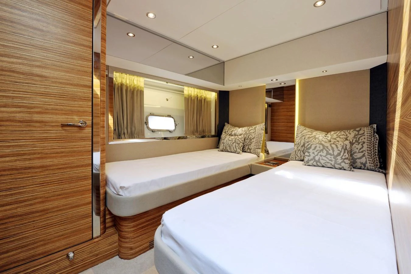 The guest stateroom features twin beds with elegant wood paneling and ample natural light. aboard SARNICO GRANDE HULL #3 Yacht for Sale