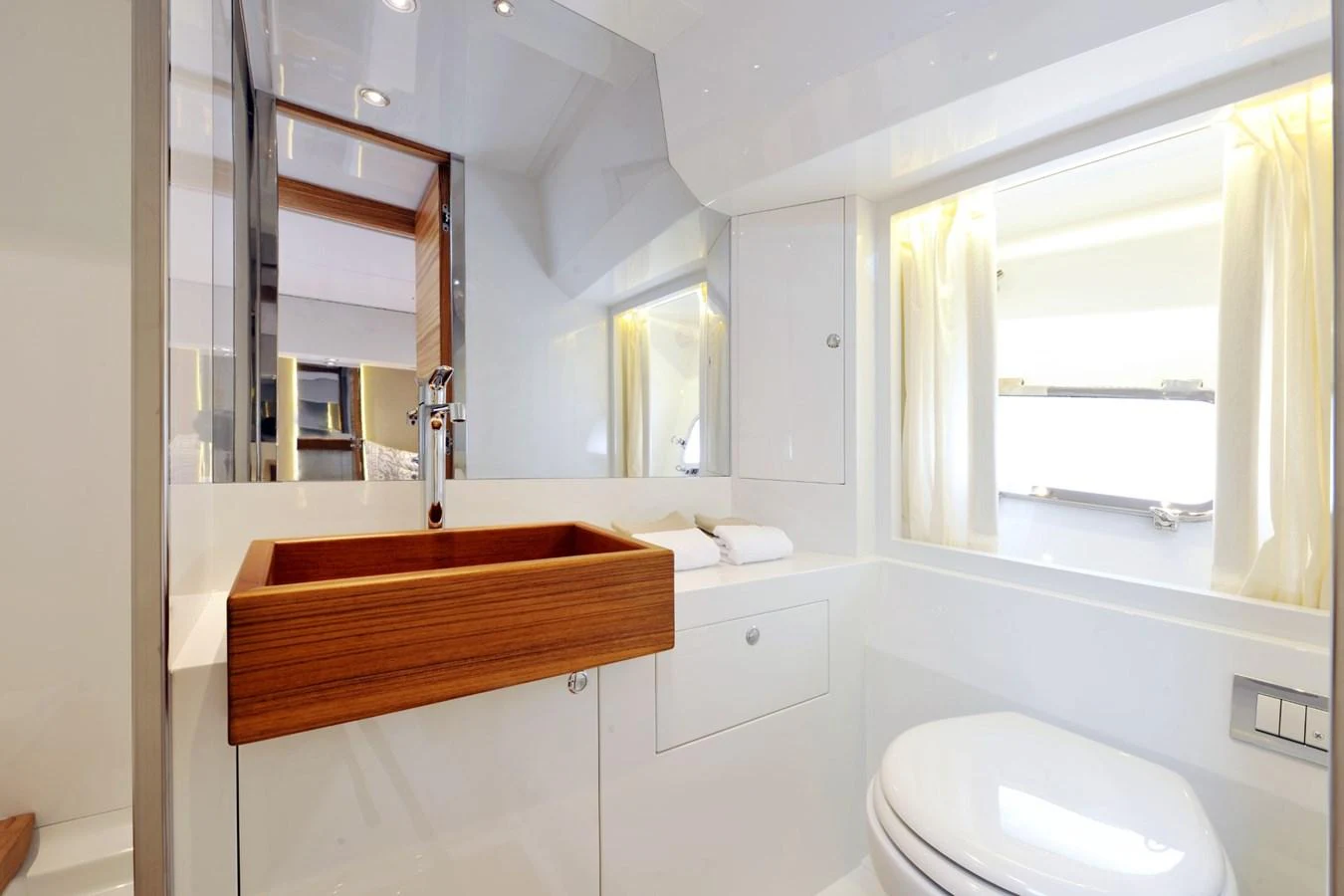 The yacht's bathroom features a sleek design with modern fixtures and ample natural light. aboard SARNICO GRANDE HULL #3 Yacht for Sale