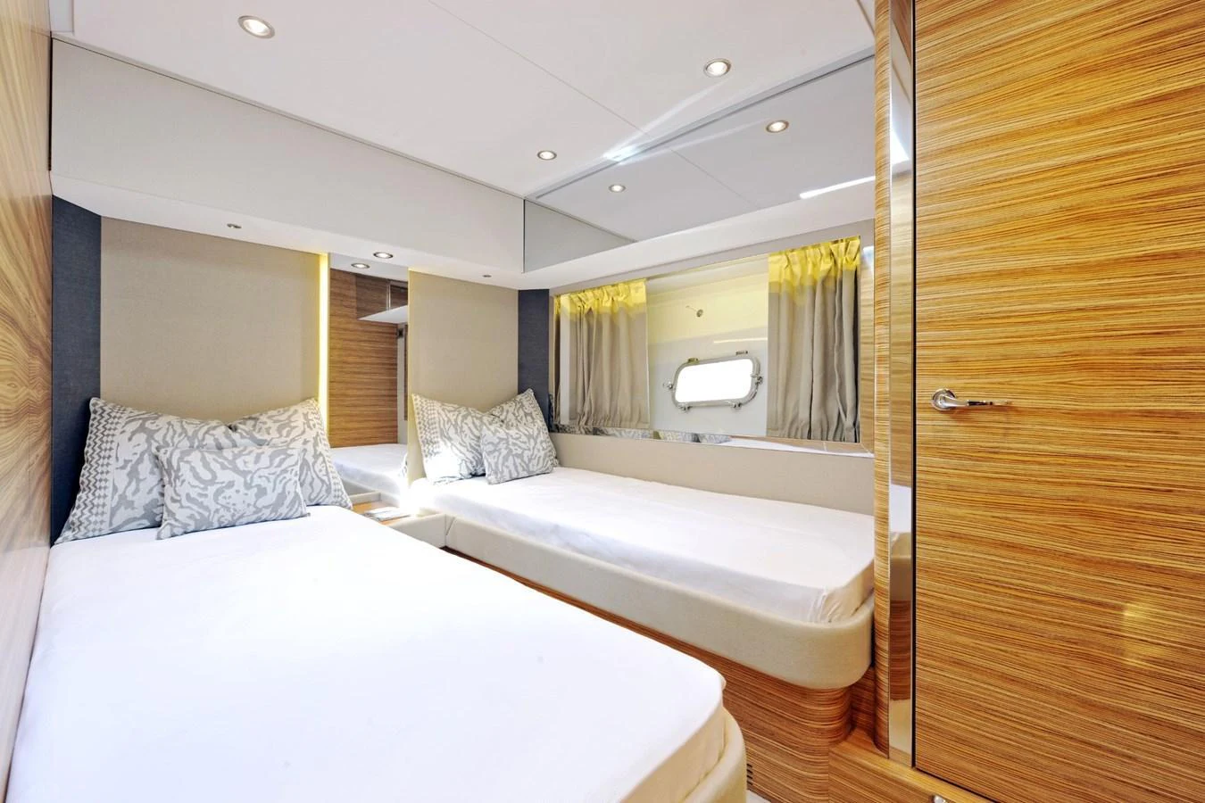 The guest stateroom features twin beds with elegant wood finishes and ample natural light. aboard SARNICO GRANDE HULL #3 Yacht for Sale