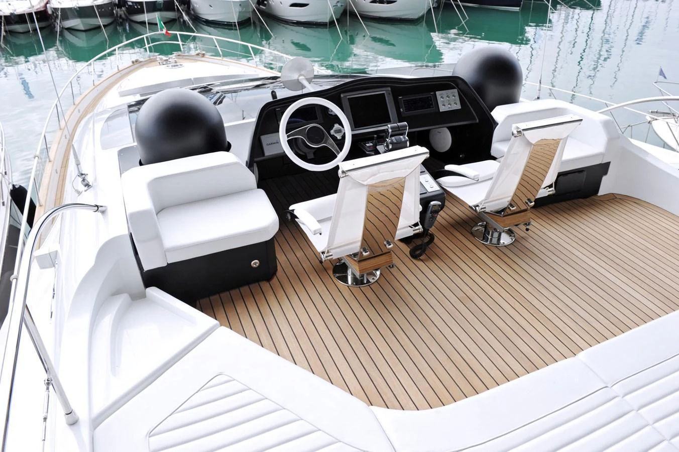 The helm station features modern controls and comfortable seating with a sleek design. aboard SARNICO GRANDE HULL #3 Yacht for Sale