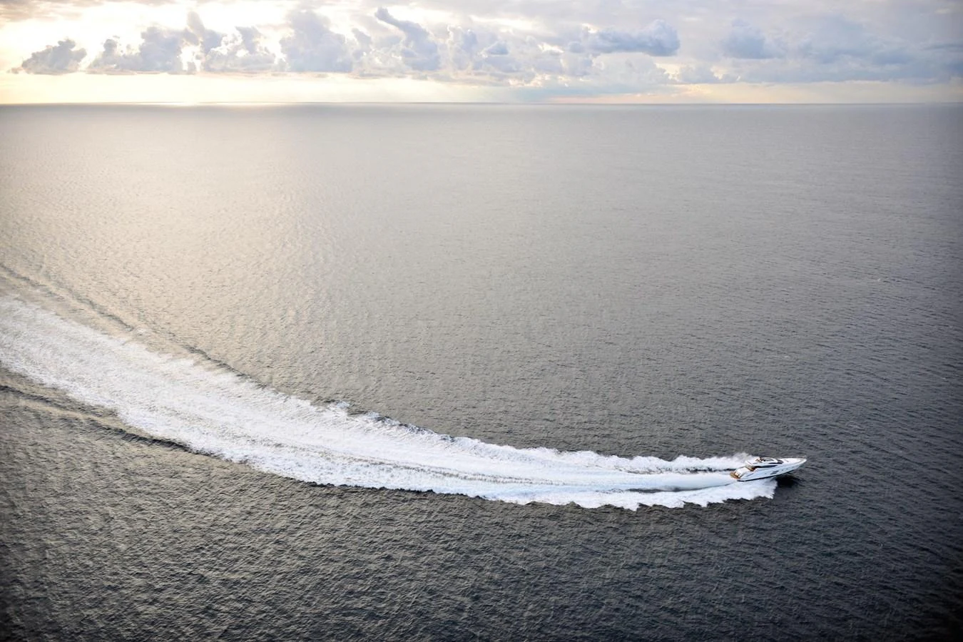 A sleek yacht cruises swiftly across the open sea, leaving a trail of white wake behind. aboard SARNICO GRANDE HULL #3 Yacht for Sale