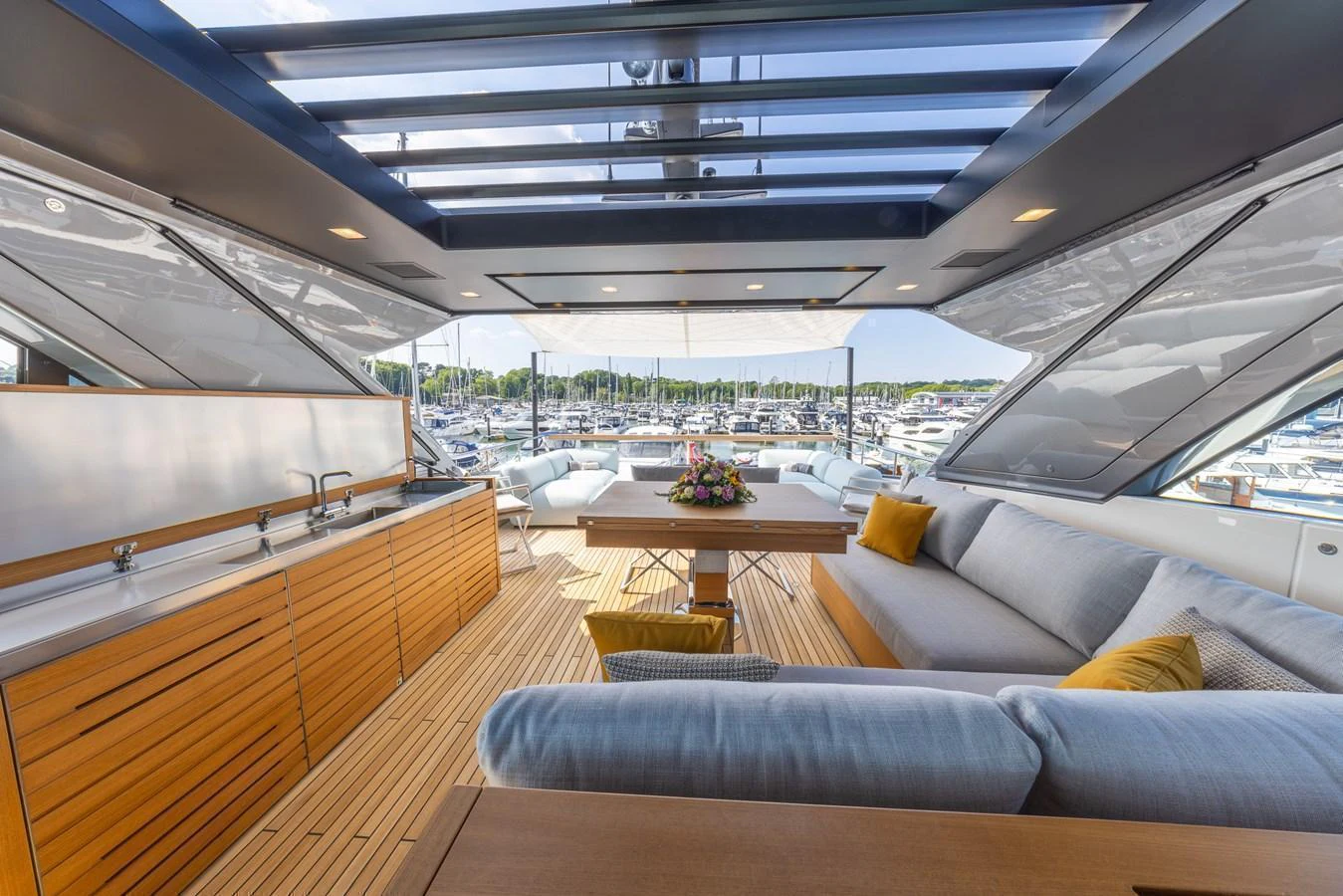 The flybridge offers a spacious and luxurious seating area with a stunning view of the marina. aboard SX76 #144 Yacht for Sale