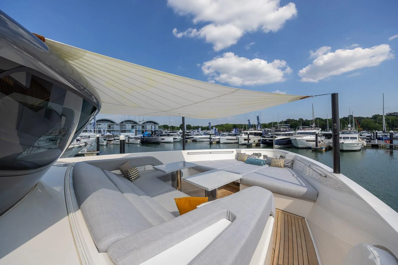 The sundeck offers a comfortable lounging area with ample seating and shade. aboard SX76 #144 Yacht for Sale
