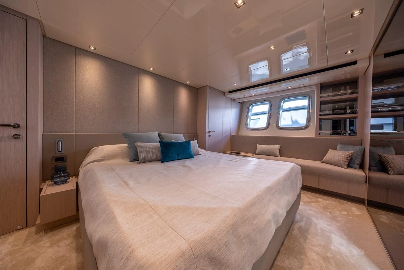 The master stateroom features a spacious bed with elegant decor and ample natural light from the windows. aboard SX76 #144 Yacht for Sale