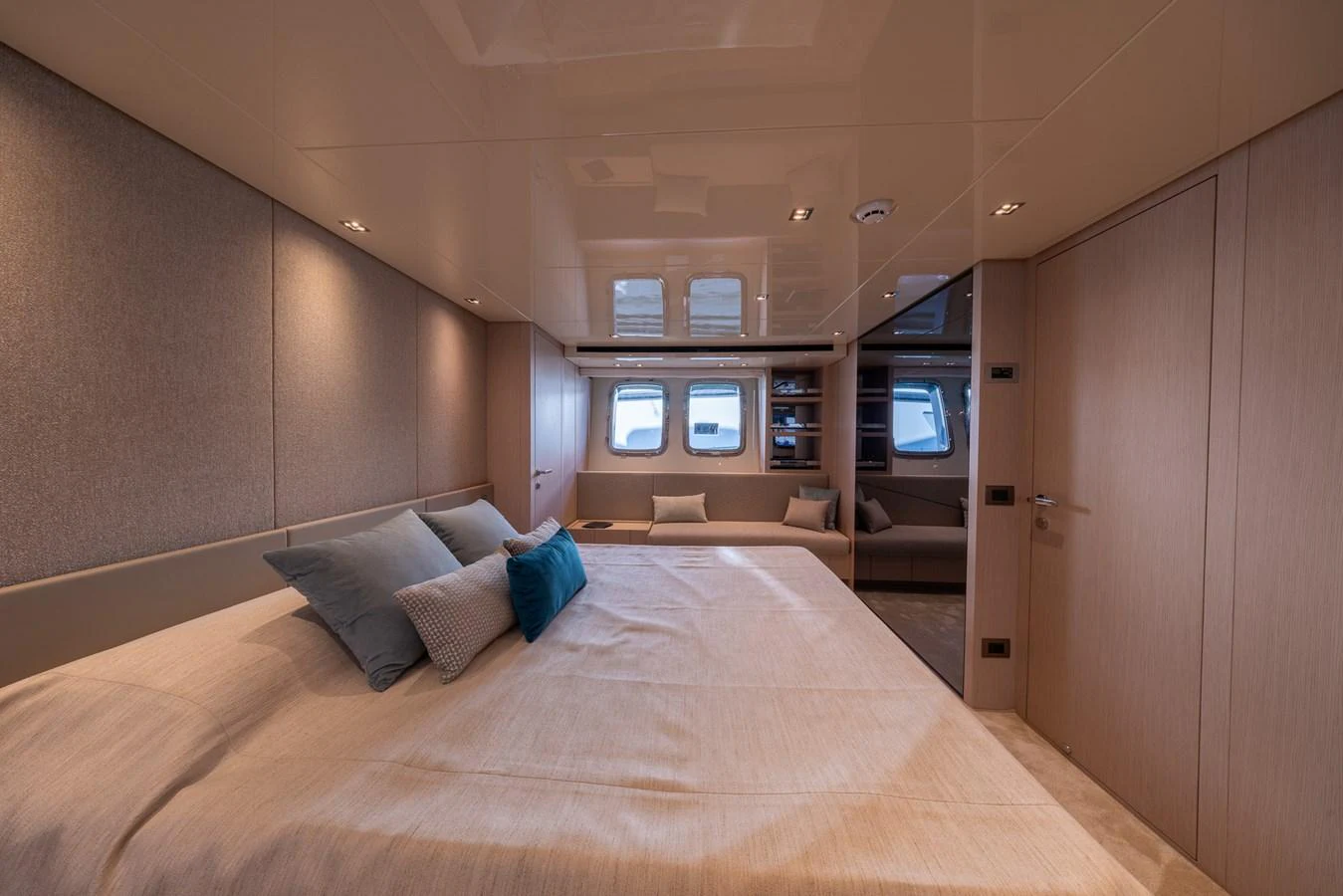 The stateroom features a spacious bed with elegant bedding and ample natural light from the windows. aboard SX76 #144 Yacht for Sale