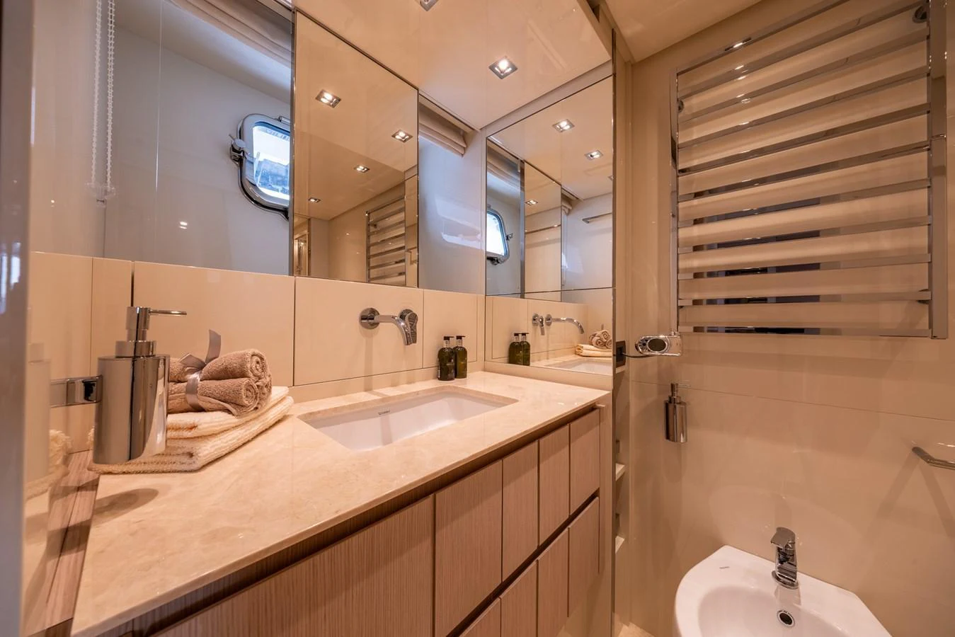 The yacht's bathroom features a sleek design with modern fixtures and ample lighting. aboard SX76 #144 Yacht for Sale