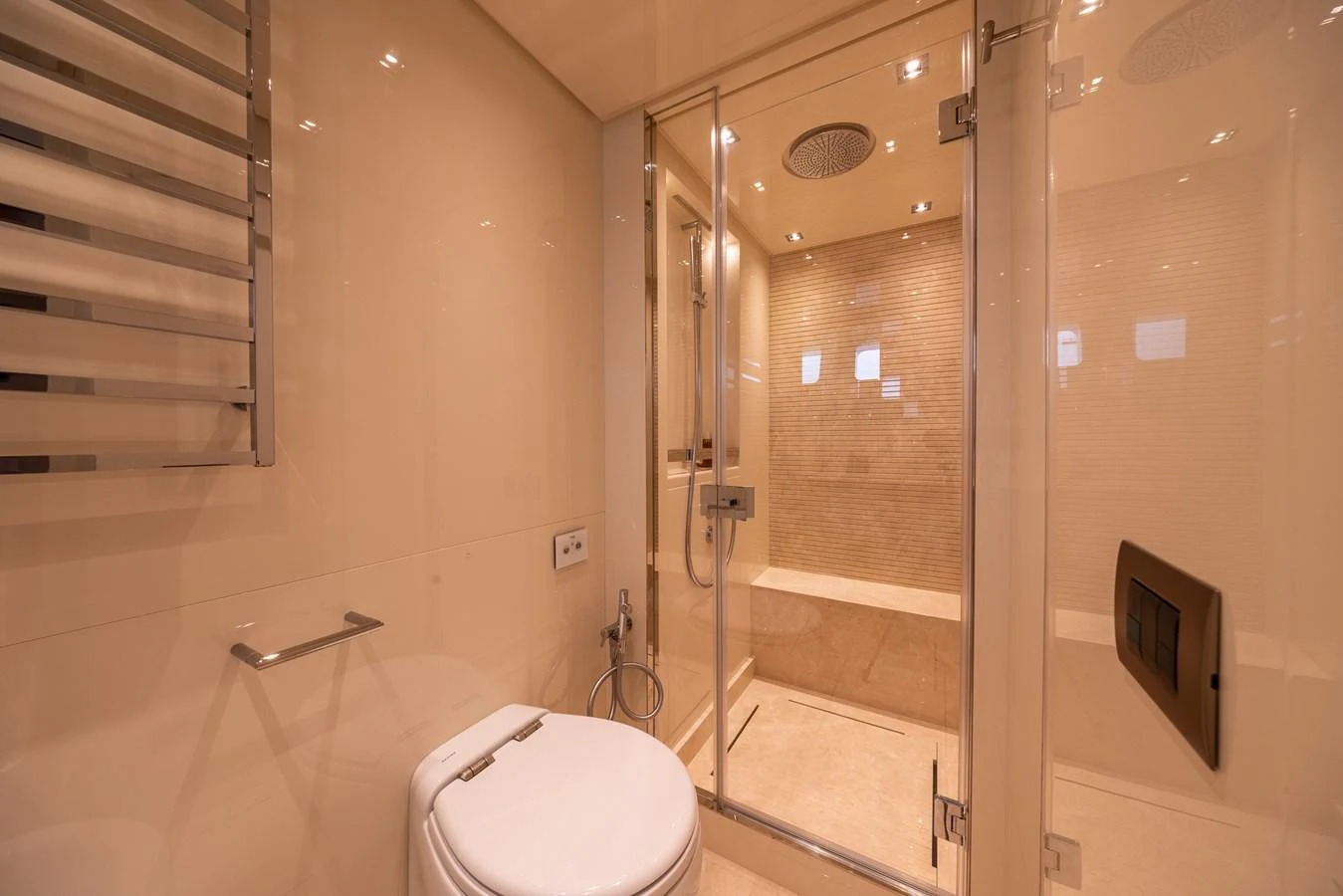 The yacht's bathroom features a modern design with a spacious shower area and elegant fixtures. aboard SX76 #144 Yacht for Sale