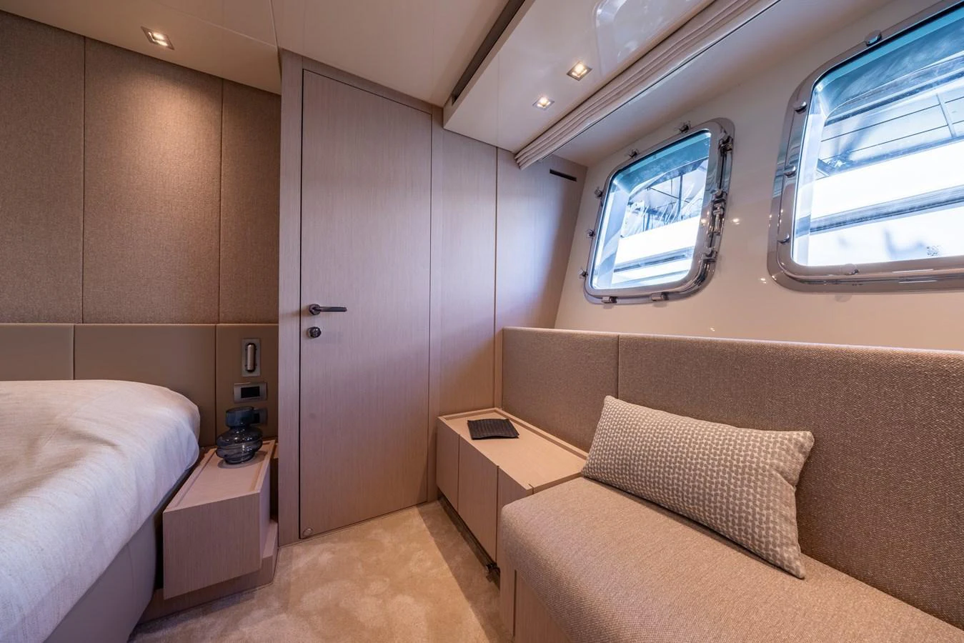 This cozy stateroom features a comfortable seating area and large windows for natural light. aboard SX76 #144 Yacht for Sale