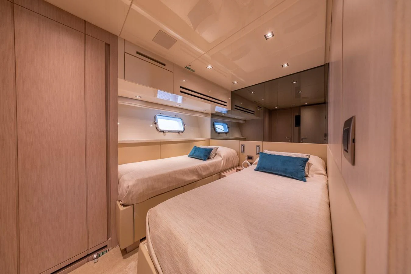 The twin stateroom offers a cozy and elegant sleeping area with two single beds and modern amenities. aboard SX76 #144 Yacht for Sale