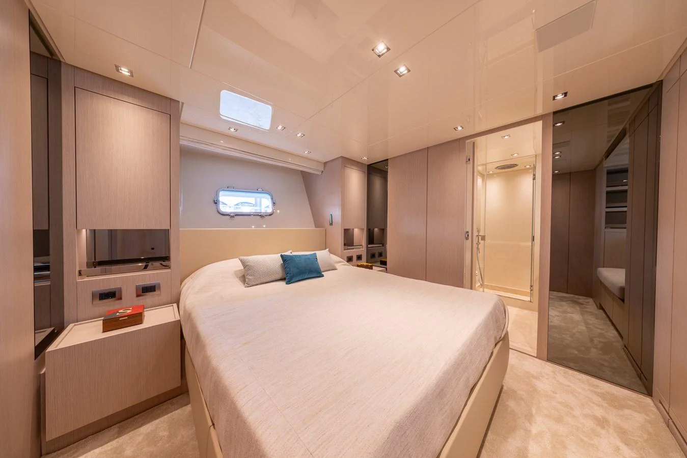 The master stateroom features a spacious bed, modern lighting, and elegant wood finishes. aboard SX76 #144 Yacht for Sale