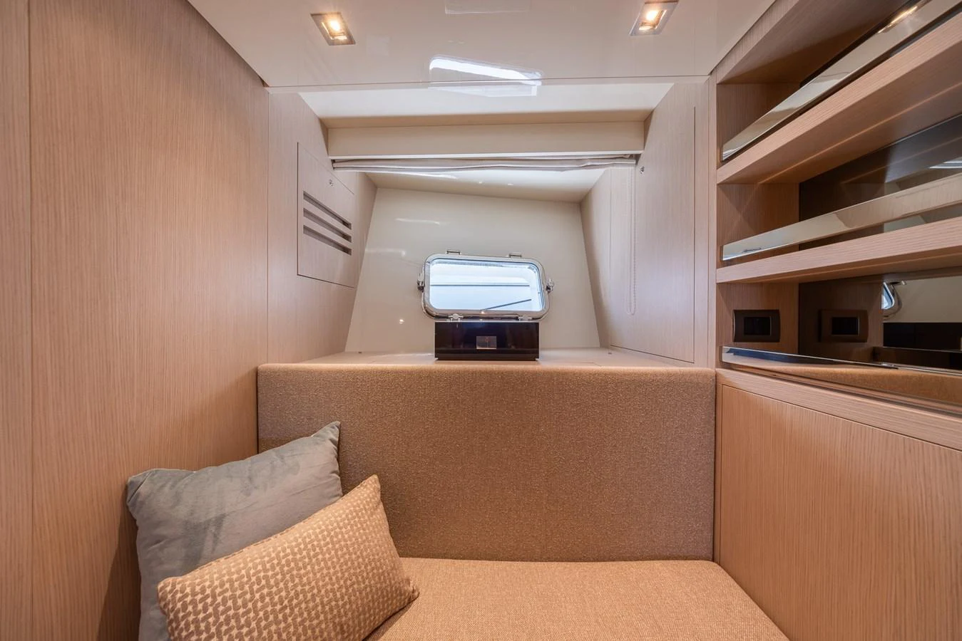 A cozy cabin with a comfortable seating area and a small window providing natural light. aboard SX76 #144 Yacht for Sale