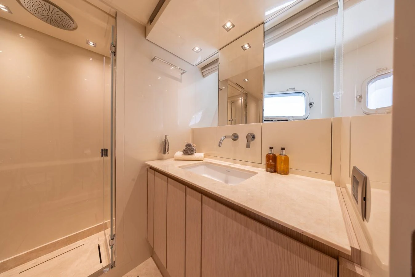 The yacht's bathroom features a sleek design with modern fixtures and ample lighting. aboard SX76 #144 Yacht for Sale