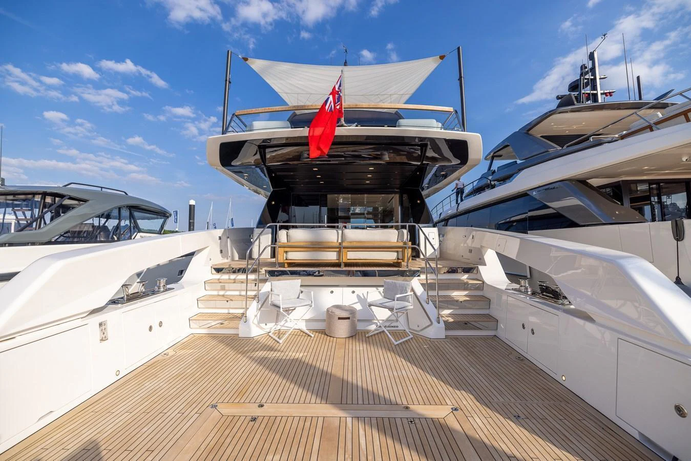 The spacious aft deck features elegant teak flooring and ample seating, perfect for outdoor relaxation. aboard SX76 #144 Yacht for Sale
