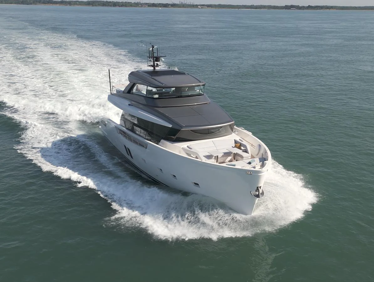 A sleek and modern yacht cruising on calm waters, showcasing its elegant design and luxurious amenities. aboard SX76 #144 Yacht for Sale