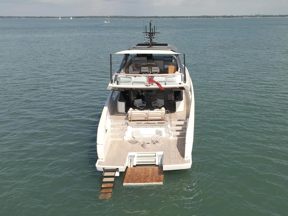 The yacht's aft deck features a spacious lounging area with direct access to the water. aboard SX76 #144 Yacht for Sale