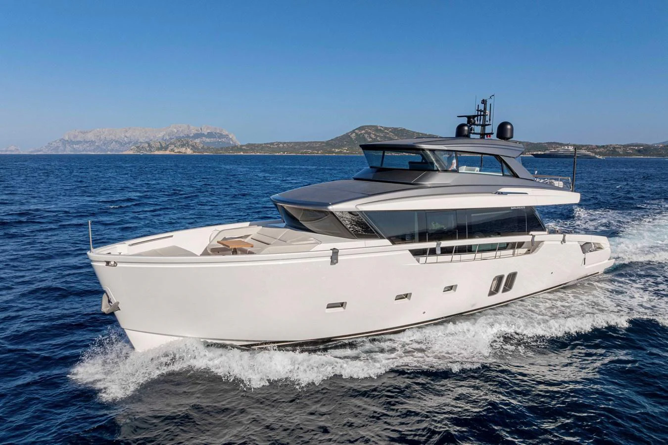 A sleek and modern yacht cruises through clear blue waters, showcasing its elegant design and spacious deck areas. aboard FIREFLY Yacht for Sale
