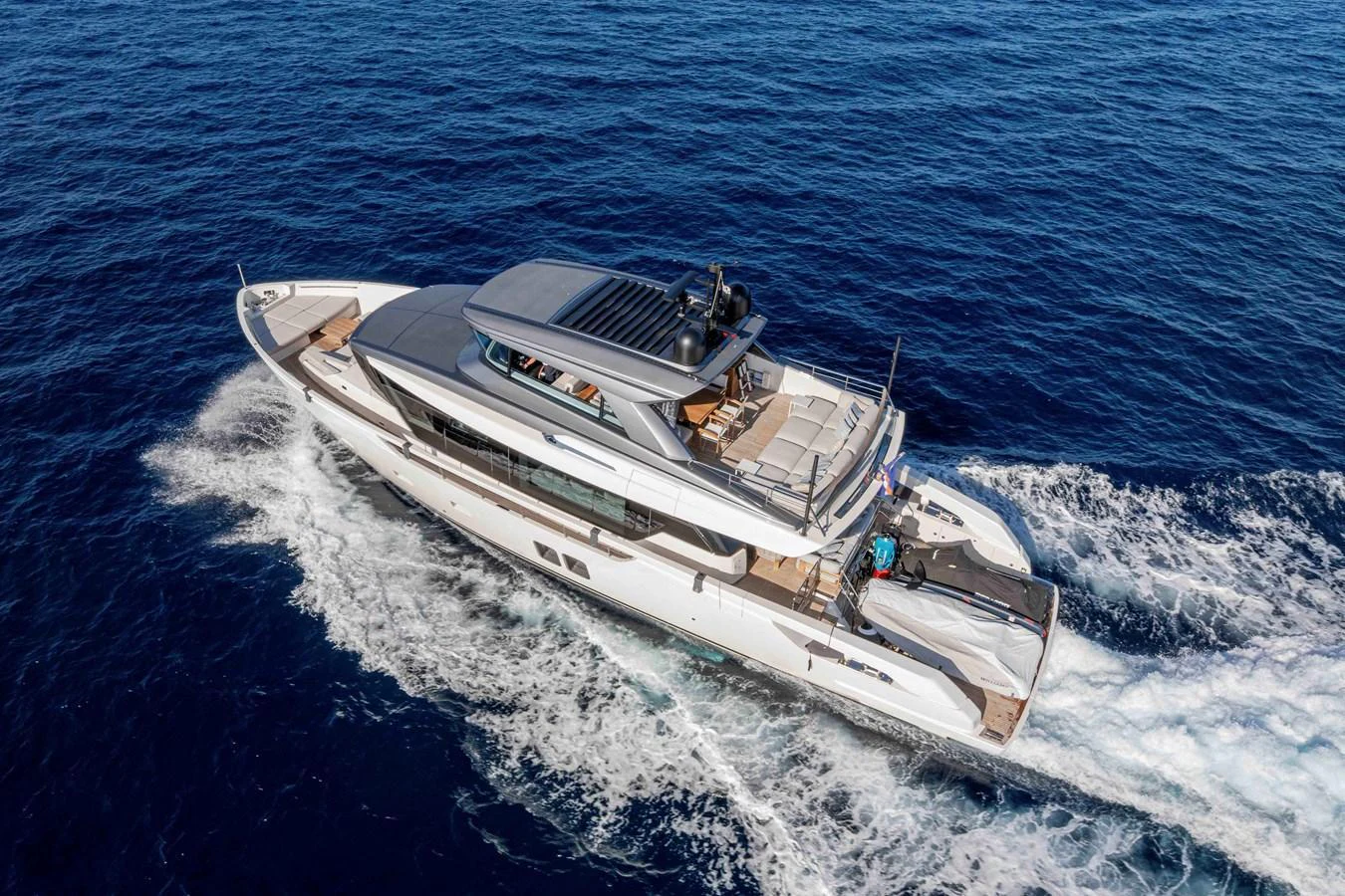 A sleek and modern yacht cruising through the open sea, showcasing its luxurious design and spacious decks. aboard FIREFLY Yacht for Sale