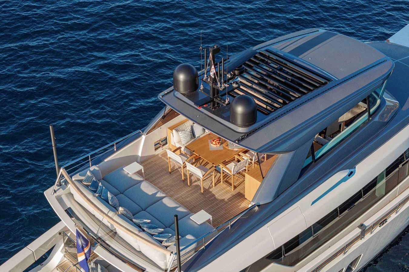 The flybridge offers a spacious dining area with panoramic ocean views. aboard FIREFLY Yacht for Sale