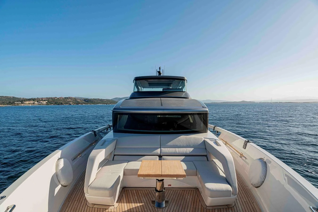 The yacht's foredeck features a stylish seating area with a central table, perfect for enjoying the ocean views. aboard FIREFLY Yacht for Sale