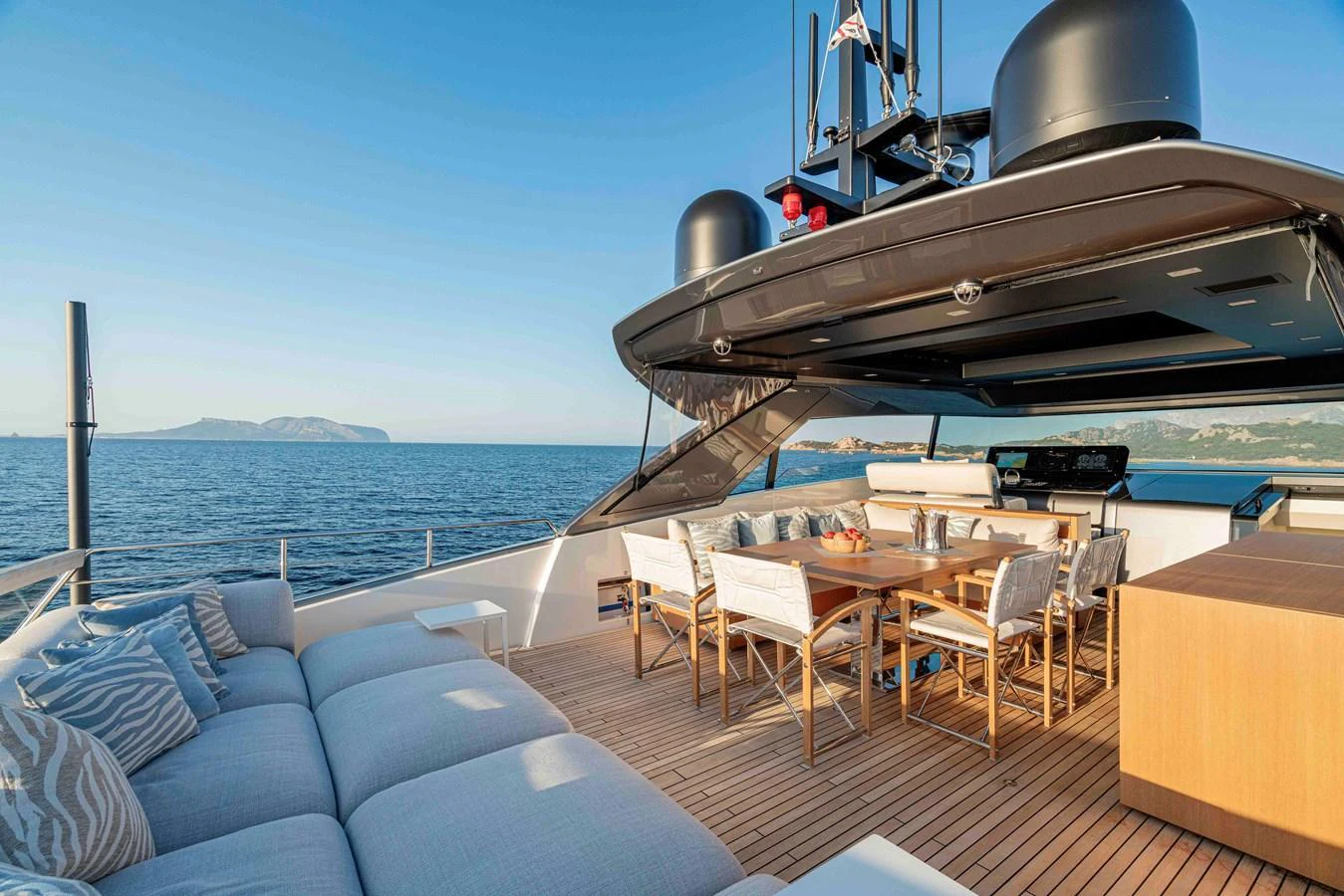 The aft deck offers a luxurious outdoor dining and lounging area with stunning sea views. aboard FIREFLY Yacht for Sale
