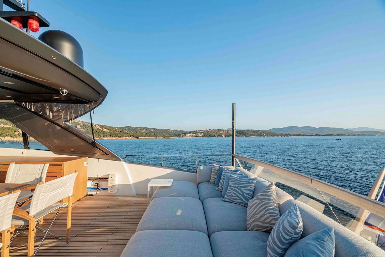 The sundeck offers a luxurious lounging area with comfortable seating and stunning ocean views. aboard FIREFLY Yacht for Sale