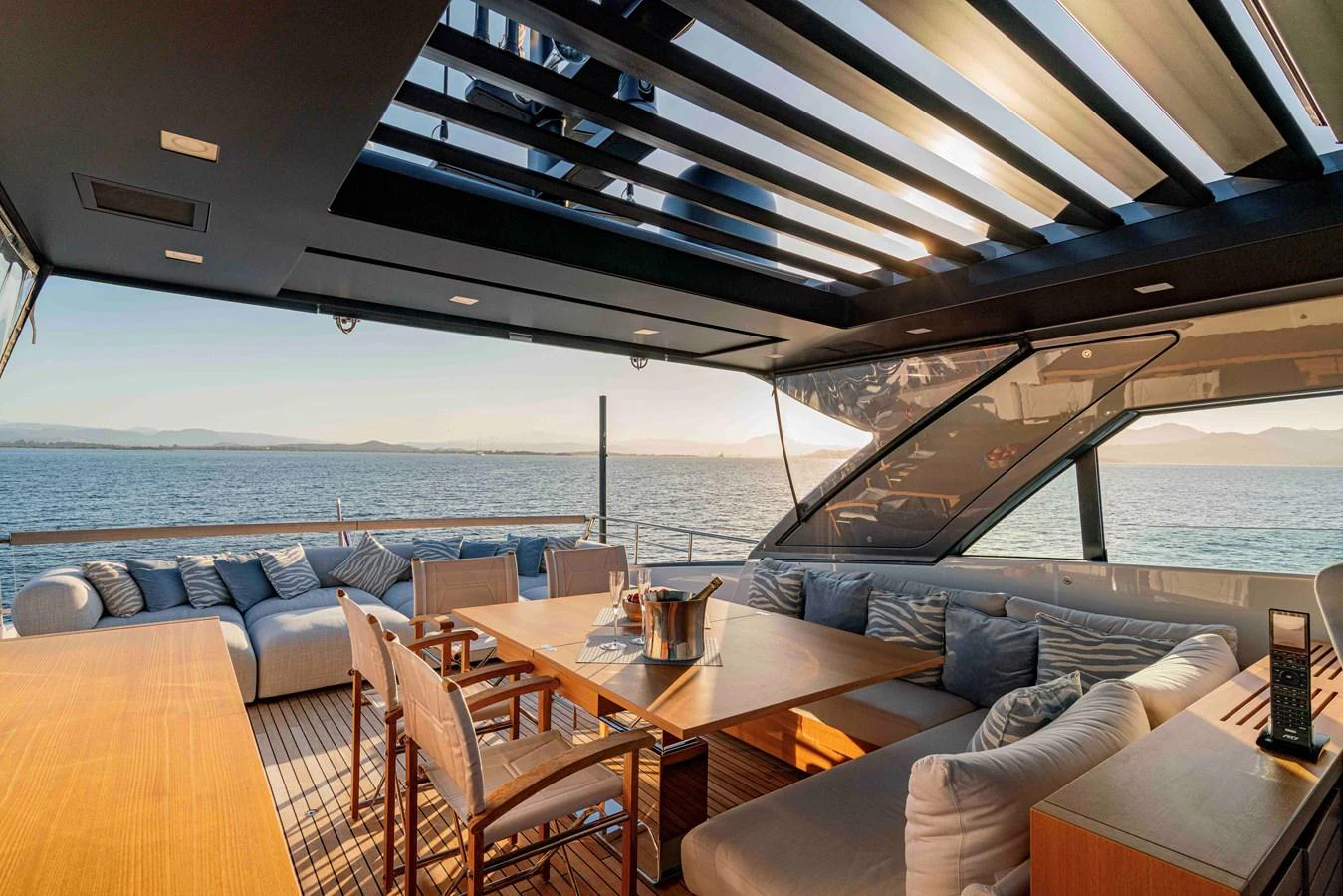 The aft deck offers a luxurious outdoor dining and lounging area with stunning sea views. aboard FIREFLY Yacht for Sale
