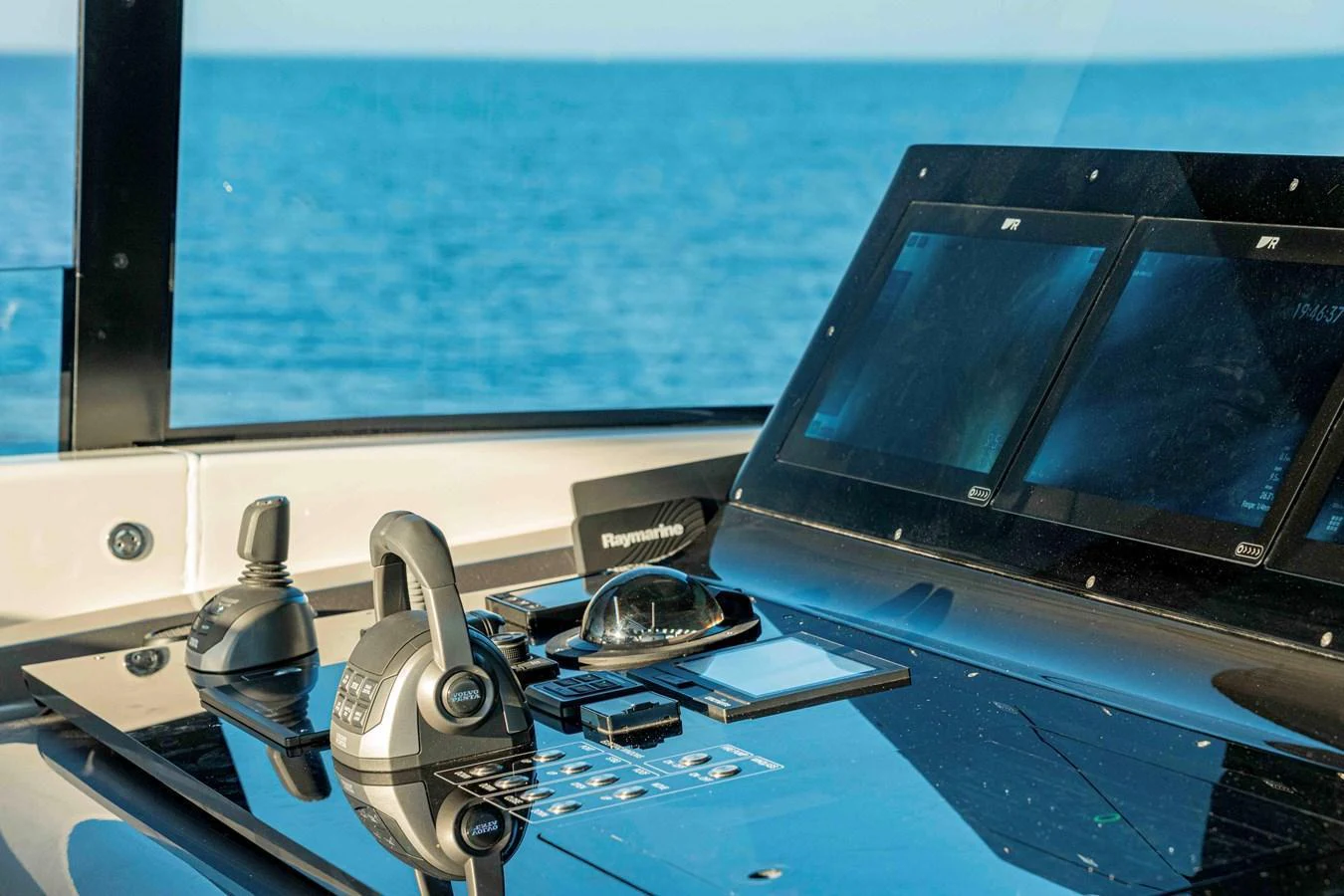 The helm station features advanced navigation equipment with a stunning ocean view. aboard FIREFLY Yacht for Sale