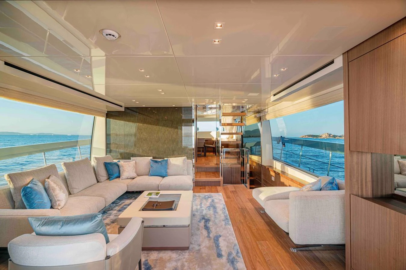 The spacious salon features luxurious seating with panoramic views of the sea. aboard FIREFLY Yacht for Sale