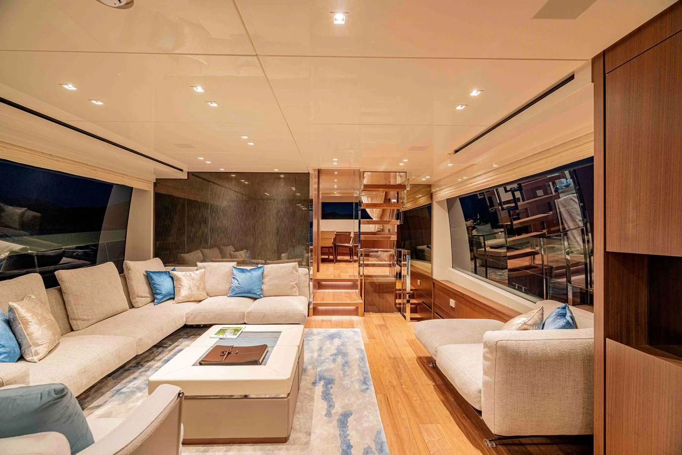 The salon features luxurious seating with a modern design and ample natural light. aboard FIREFLY Yacht for Sale