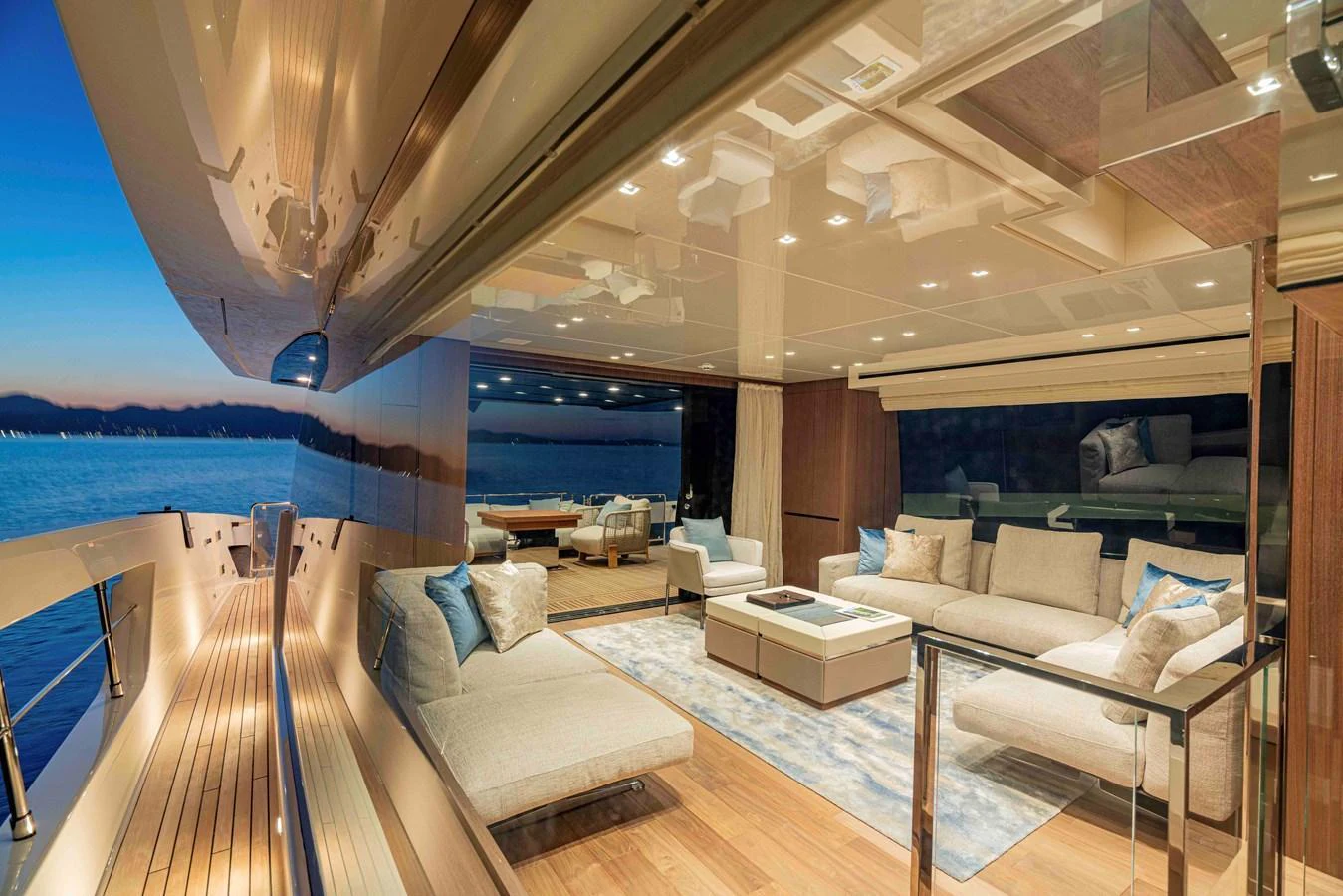 The yacht's salon offers a luxurious and spacious living area with elegant furnishings and a stunning view of the water. aboard FIREFLY Yacht for Sale